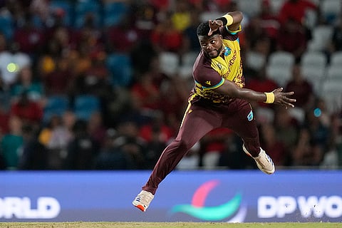 Romario Shepherd bowls against New Zealand